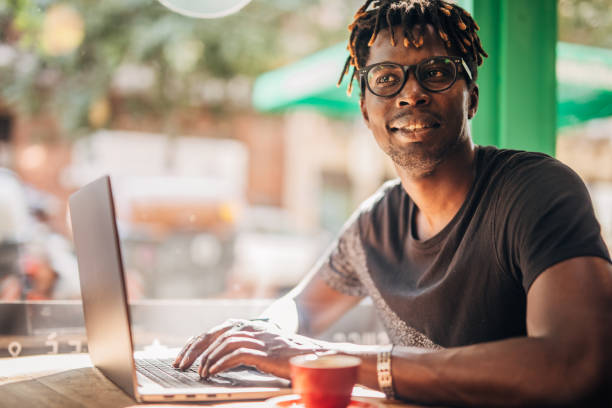 istock Man sitting in coffee shop and using laptop 1203736852