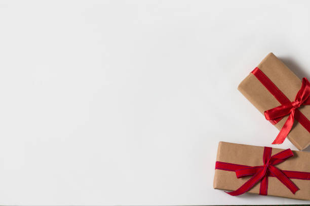 istock Two presents with red ribbons on a white background 1203740780