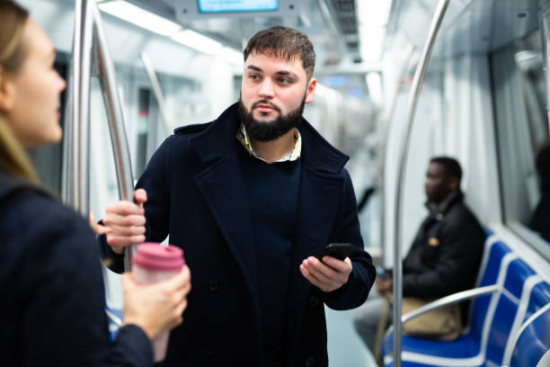 istock Young man talking with woman in subway 1203741021