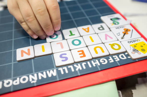 istock Child practices with word formation board game 1203742447