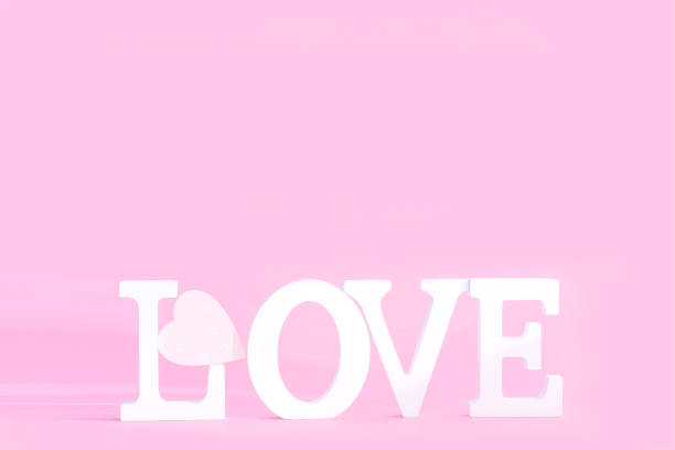 istock Word love from white volume letters on pink background 1203743871