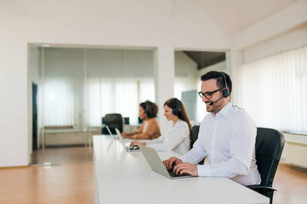 istock Beautiful people working in modern customer support office. 1203743941