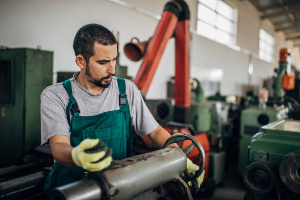 istock Young man working in metal factory 1203745273