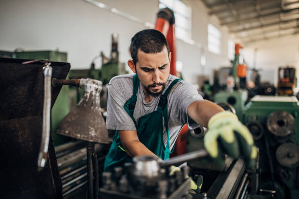 istock Young man working in metal factory 1203745351