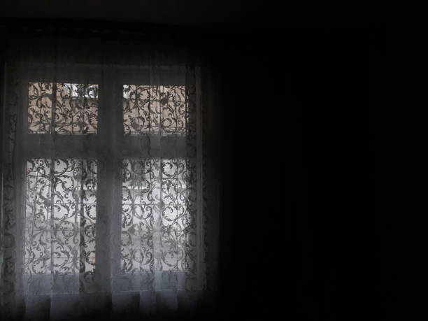 istock Dark room and bright windows and curtains 1203745433