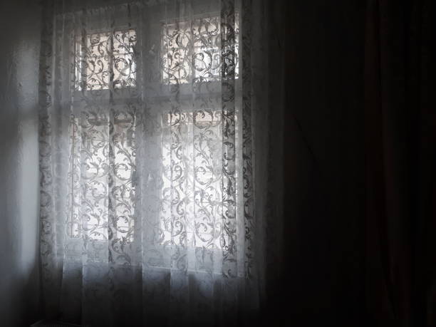 istock Dark room and bright windows and curtains 1203745541