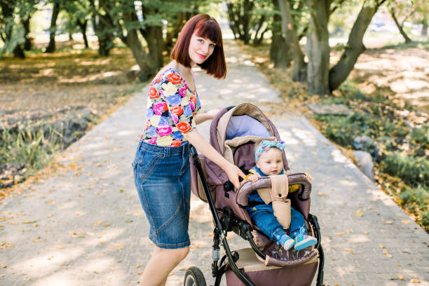 istock Young mother looking at her child in a baby stroller 1203745635