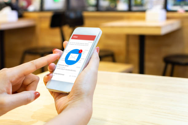 istock Hand of female checking application email on smart phone. Notification new messages on mobile smartphone 1203745940