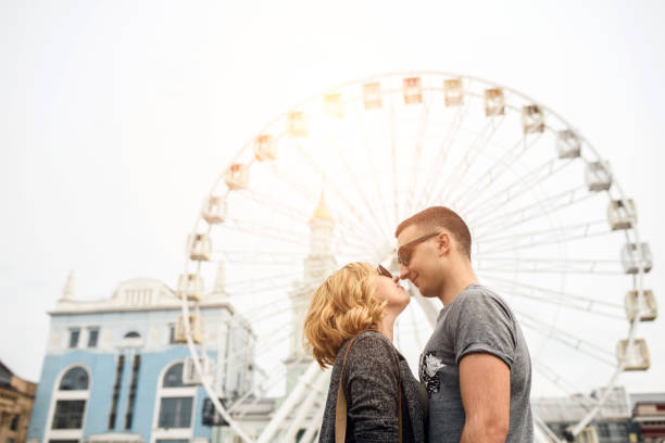istock Loving couple with sight wheel on background 1203747353