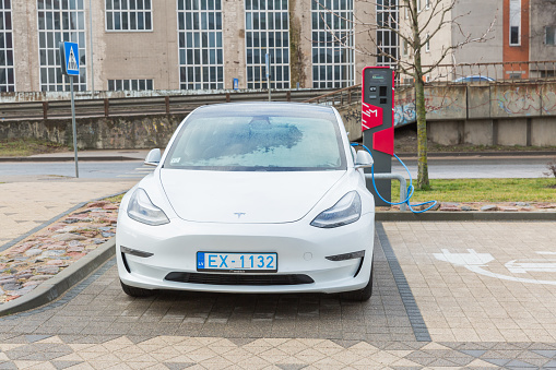City Riga, Latvia. The electric car is being charged in the parking lot. 03.02.2020