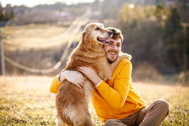 istock Man with his dog at sunset 1203749244