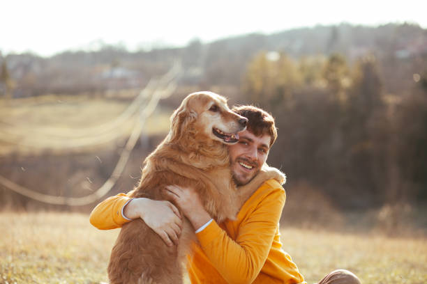 istock Man with his dog at sunset 1203749316