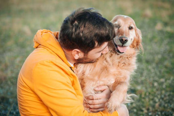 istock Man with his dog at sunset 1203749373