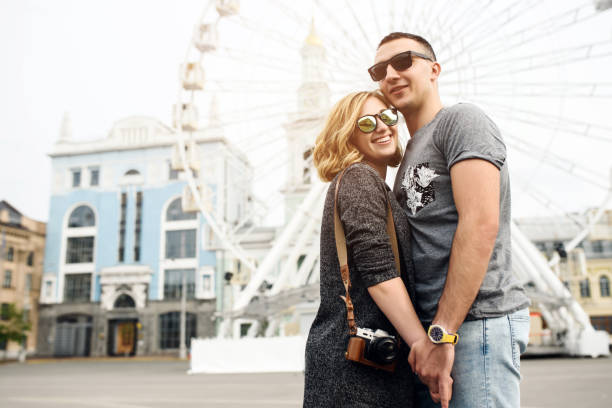 istock Loving couple with sight wheel on background 1203749564
