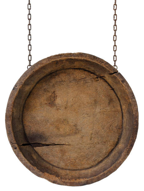 Old weathered worn circular wooden board sign panel, hanging by old rusty chains, isolated on white, clipping path included. The panel is very rustic with lots of weathering detail.