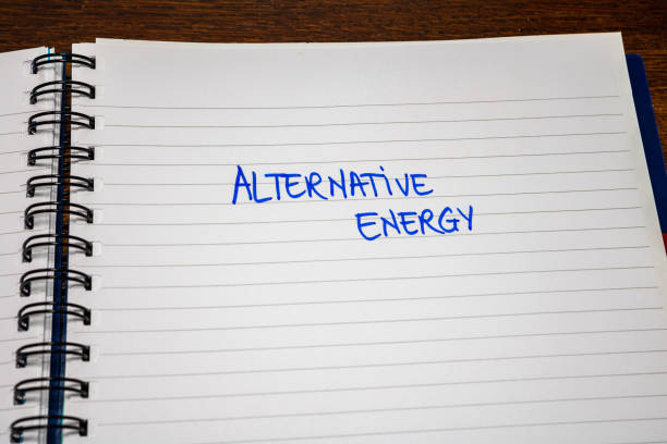 istock Alternative energy handwriting  text on paper, on office agenda. Copy space. 1203750835