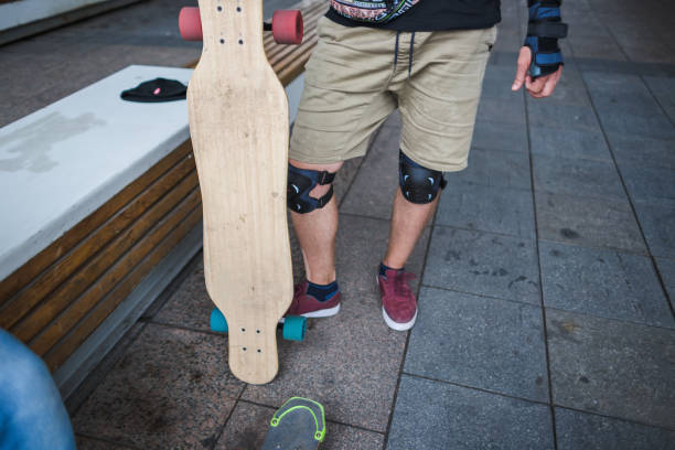istock Young skater with longboard and body protection 1203751674