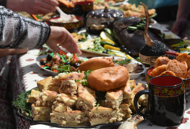 istock Russian pie slice-cutted on the table with various fish dishes 1203751937