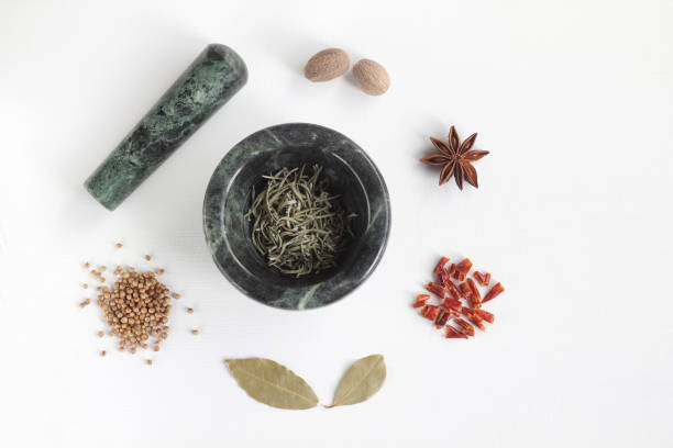 rosemary, badian, red pepper, bay leaf, coriander and  nutmeg on white background - mortar and pestle spice seasoning coriander seed imagens e fotografias de stock