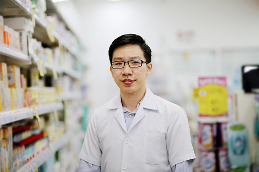 Portrait of male adult pharmacist in pharmacy.