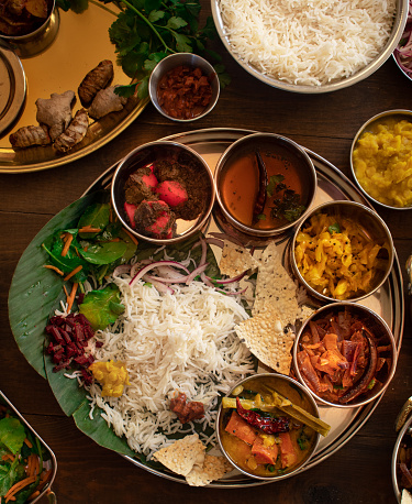 South Indian thali dishes served in a variety of traditional plates
