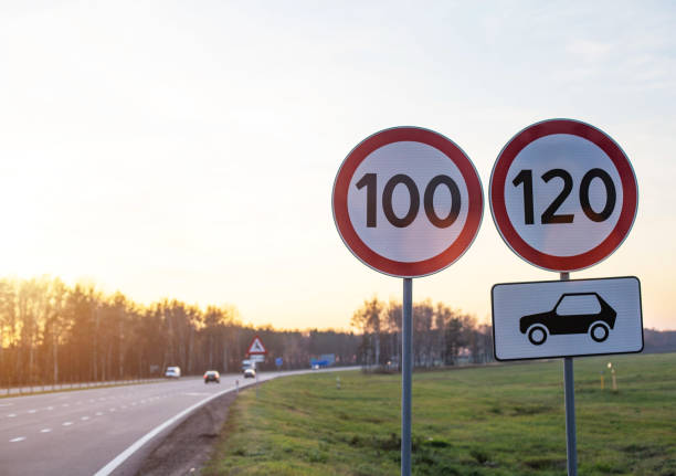 Traffic signs limit the maximum speed on the motorway. Speed and Safety Compliance Concept, copy space Traffic signs limit the maximum speed on the motorway. Speed and Safety Compliance Concept, copy space, summer 100 mph stock pictures, royalty-free photos & images