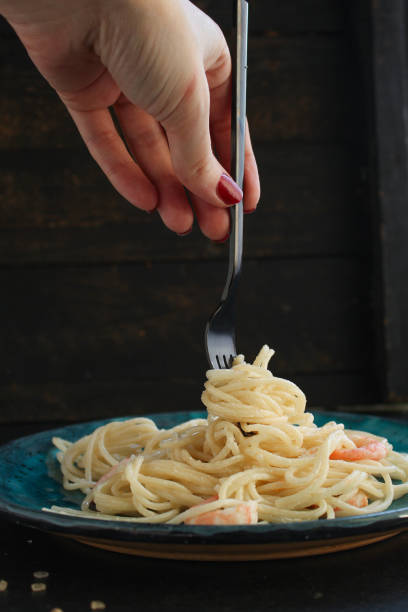 istock pasta prawn (spaghetti shrimp cream sauce and seafood ) menu concept. food background. top view. copy space 1203755898