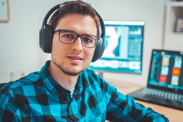 istock Young freelancer is sitting in his home office and working on a creative project 1203756270