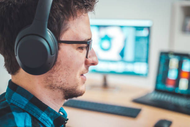 istock Young freelancer is sitting in his home office and working on a creative project 1203756283