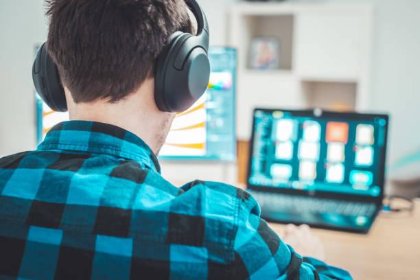 istock Young freelancer is sitting in his home office and working on a creative project 1203756293