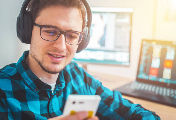 istock Young freelancer is sitting in his home office and working on a creative project 1203756310