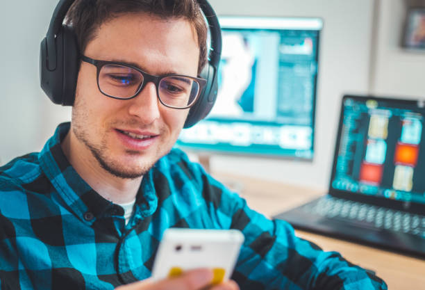 istock Young freelancer is sitting in his home office and working on a creative project 1203756337