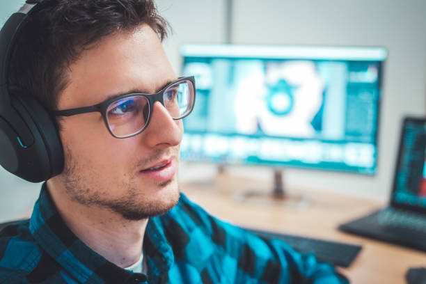 istock Young freelancer is sitting in his home office and working on a creative project 1203756340