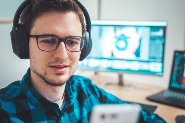 istock Young freelancer is sitting in his home office and working on a creative project 1203756380