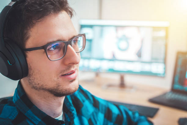 istock Young freelancer is sitting in his home office and working on a creative project 1203756383