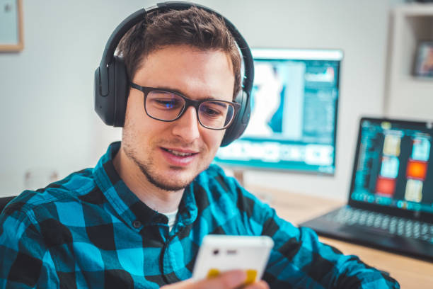 istock Young freelancer is sitting in his home office and working on a creative project 1203756436