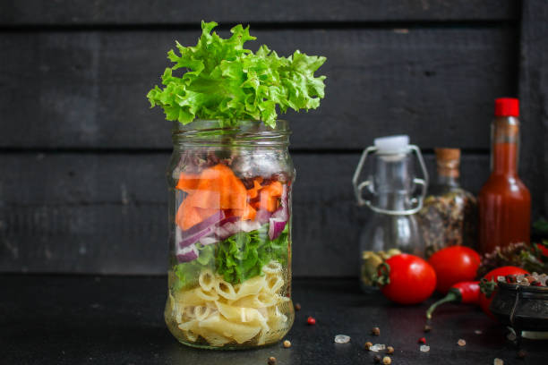 istock healthy salad in a jar (vegetable snack pasta salad) menu concept. food background. top view. copy space 1203756489