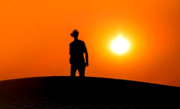 istock Silhouette of man sunset in desert 1203757549
