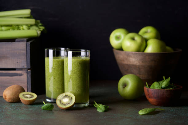 istock Glasses with green smoothie on  dark background 1203757570