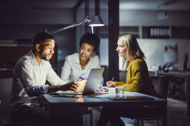 istock Business people working in the office at night 1203758034