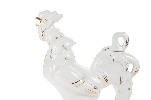 Porcelain carafe in the form of a rooster on a white background