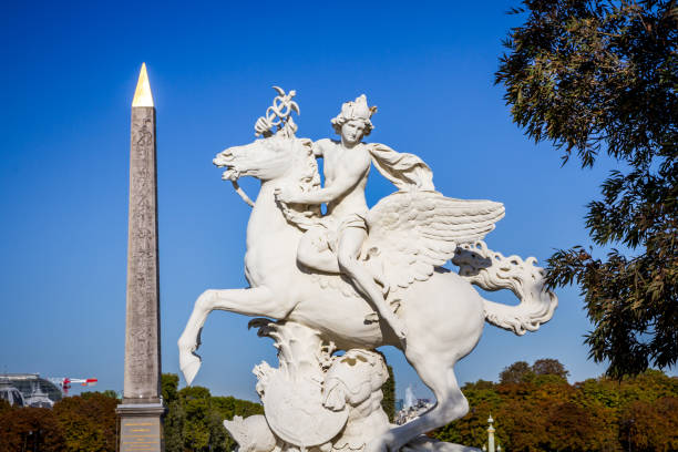istock Marble statue and Obelisk of Luxor in Concorde square, Paris 1203759433