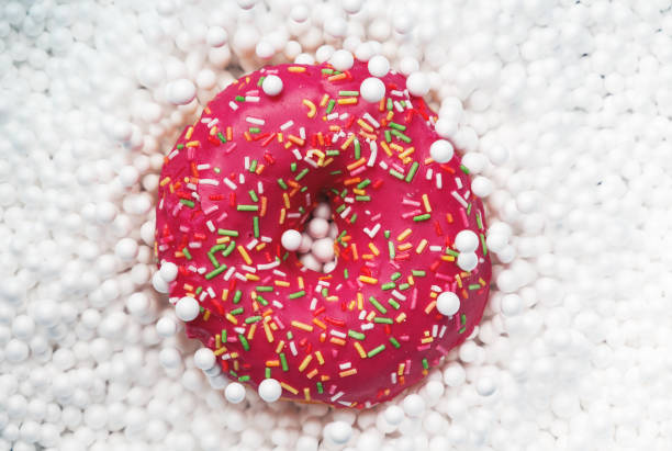 Red Donut and white balloons, top view