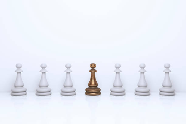 Unique Pawn Standing Out From the Crowd stock photo