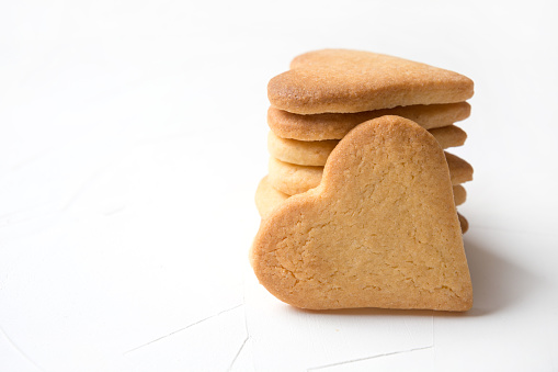Homemade heart shaped cookies on white table.Close up. Valentines day greeting card.