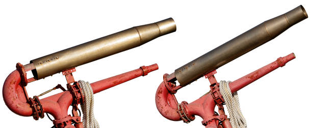istock Two old water cannons isolated on white background 1203760812