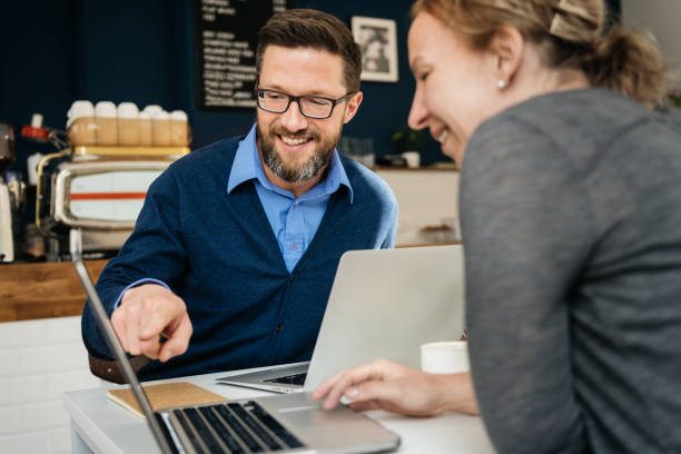 istock Man Showing Business Partner Document On Laptop 1203762865