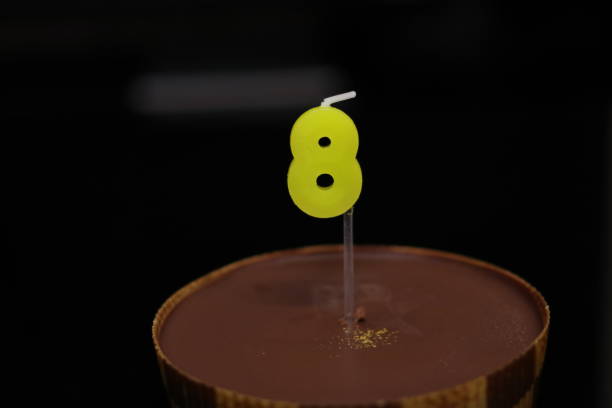 chocolate cake with candles in the shape of 8 - dark chocolate audio imagens e fotografias de stock