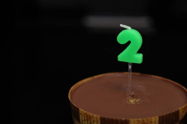 chocolate cake with candles in the shape of 2 - dark chocolate audio imagens e fotografias de stock