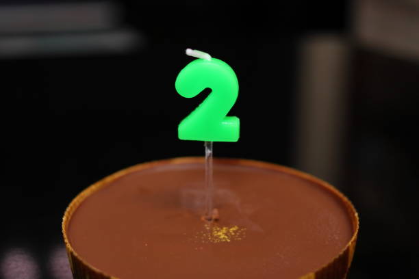 chocolate cake with candles in the shape of 2 - dark chocolate audio imagens e fotografias de stock